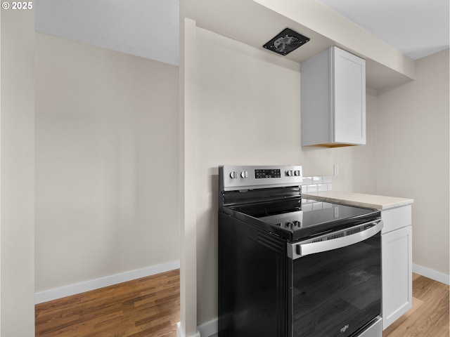 24033 SE Oak St, Gresham, OR 97030 - kitchen with electric range, light wood-style floors, white cabinets, baseboards, and light countertops