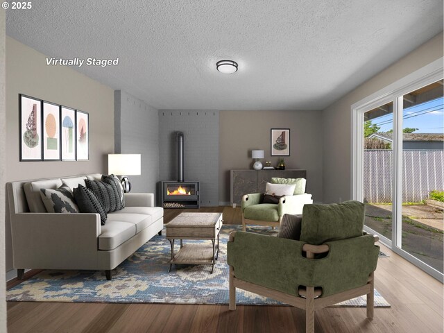 24033 SE Oak St, Gresham, OR 97030 - living area featuring a textured ceiling, wood finished floors, and a wood stove