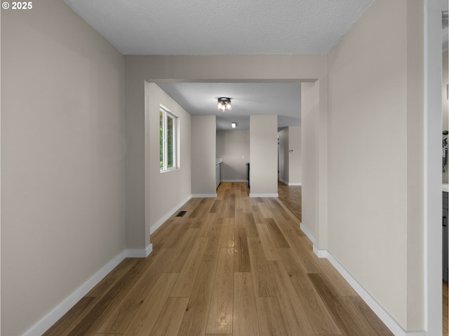 24033 SE Oak St, Gresham, OR 97030 - corridor featuring light wood-type flooring, baseboards, and a textured ceiling