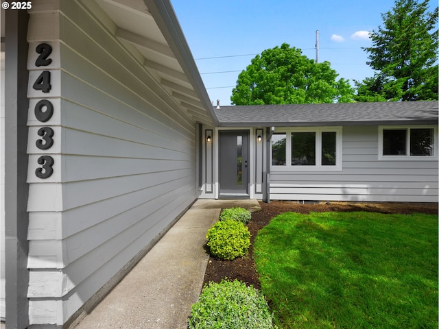 24033 SE Oak St, Gresham, OR 97030 - view of exterior entry with a shingled roof and a lawn