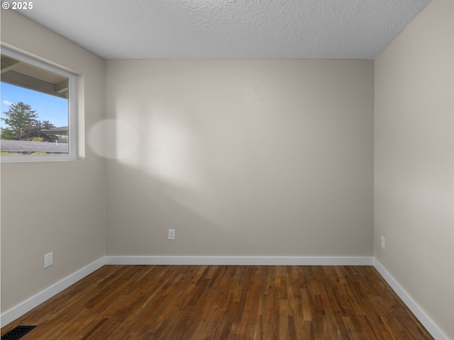 24033 SE Oak St, Gresham, OR 97030 - empty room featuring dark wood-style flooring, baseboards, and a textured ceiling