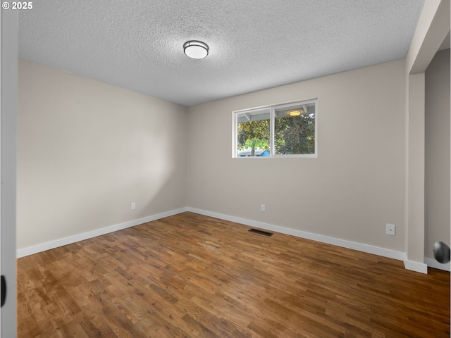 24033 SE Oak St, Gresham, OR 97030 - unfurnished room featuring wood finished floors, a textured ceiling, and baseboards