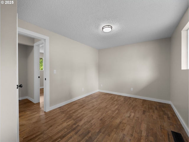 24033 SE Oak St, Gresham, OR 97030 - spare room with wood finished floors, a textured ceiling, and baseboards