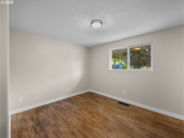24033 SE Oak St, Gresham, OR 97030 - spare room with wood finished floors, a textured ceiling, and baseboards