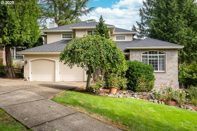 view of front of house featuring a front yard and a garage