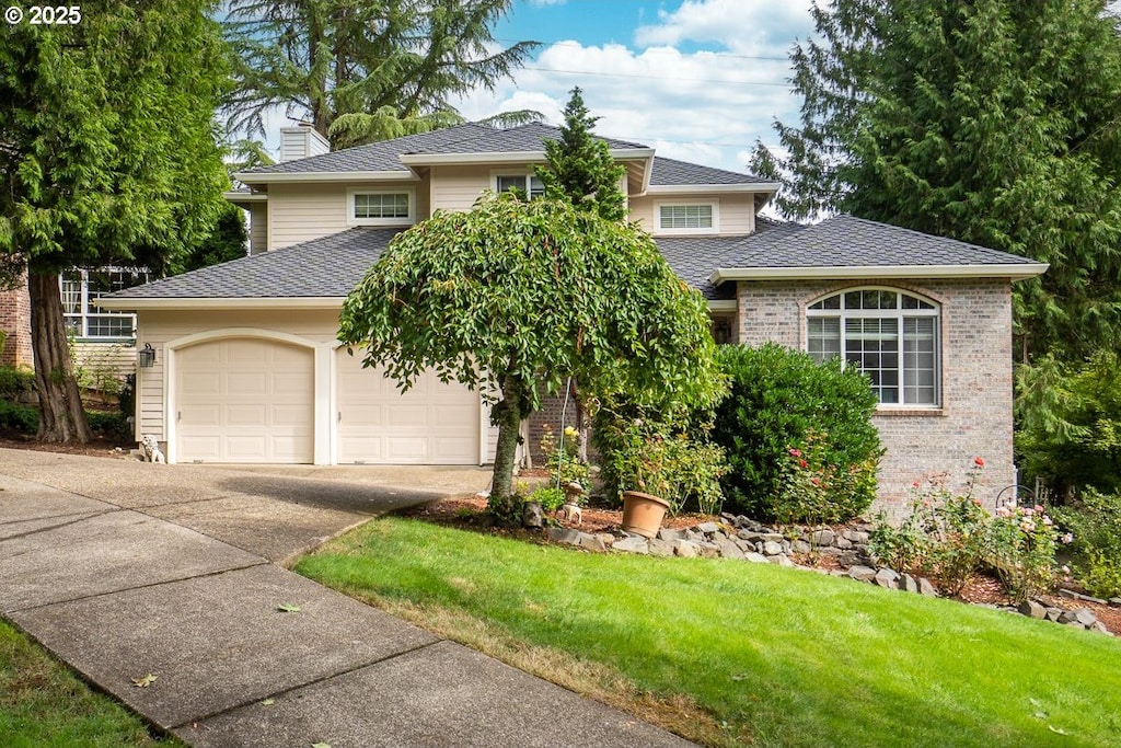 view of front of house featuring a garage and a front lawn