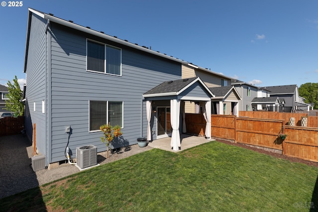 46 Shore Dr, Saint Helens, OR 97051 - back of house with central air condition unit, a yard, fence, and a patio