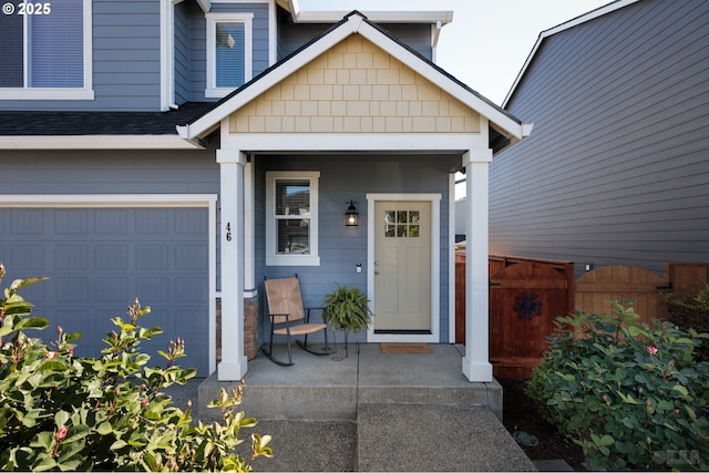 46 Shore Dr, Saint Helens, OR 97051 - doorway to property featuring a porch, roof with shingles, an attached garage, and fence