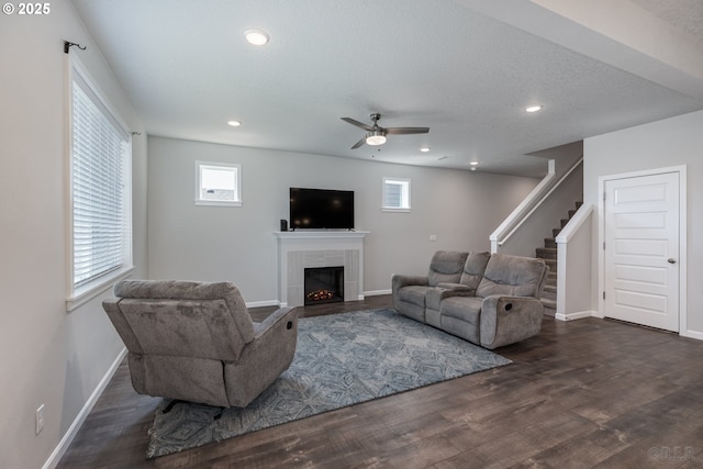 46 Shore Dr, Saint Helens, OR 97051 - living room with a tiled fireplace, stairway, baseboards, ceiling fan, and dark wood-style floors