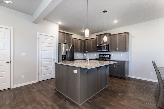 46 Shore Dr, Saint Helens, OR 97051 - kitchen featuring a sink, stainless steel appliances, tasteful backsplash, dark wood-type flooring, and dark brown cabinetry