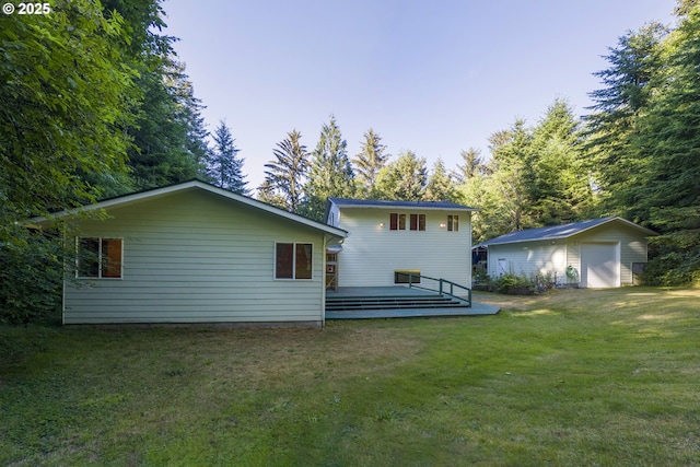 594 NE Newport Heights Dr, Newport, OR 97365 - back of house with a lawn, an outbuilding, a detached garage, and a deck