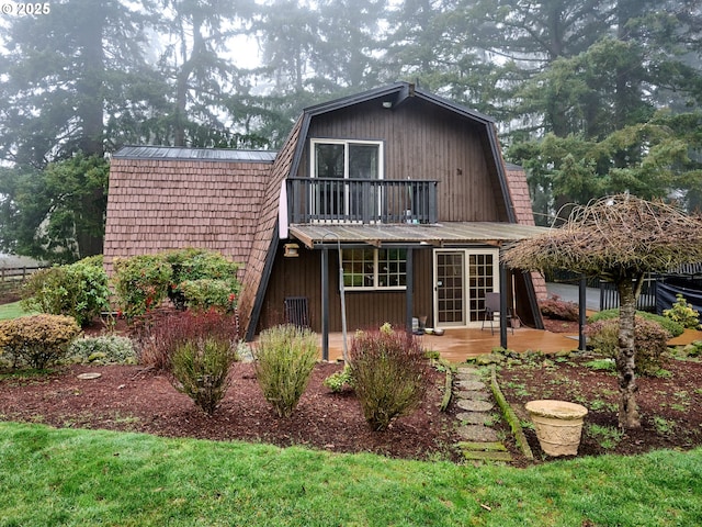 rear view of house featuring a balcony