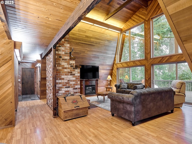 living room featuring a large fireplace, wooden walls, hardwood / wood-style flooring, high vaulted ceiling, and wooden ceiling