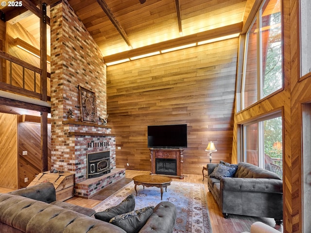 living room featuring wood ceiling, hardwood / wood-style floors, wooden walls, high vaulted ceiling, and beam ceiling