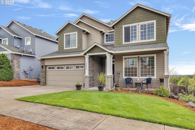 craftsman-style home with driveway, covered porch, roof with shingles, a front yard, and an attached garage