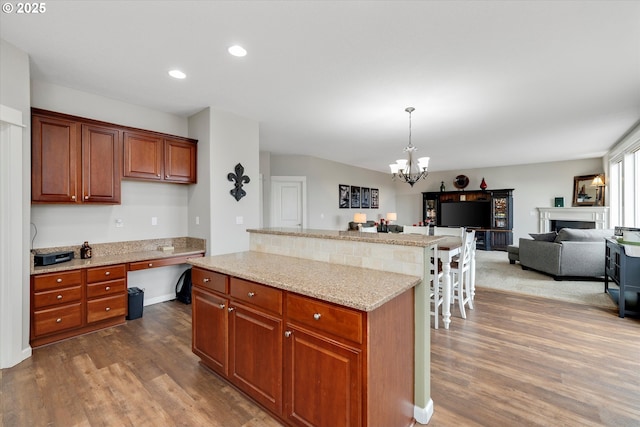 kitchen with open floor plan, dark wood-style flooring, a chandelier, a center island, and recessed lighting