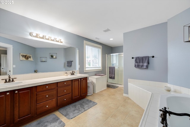 bathroom featuring visible vents, a stall shower, a sink, double vanity, and a bath