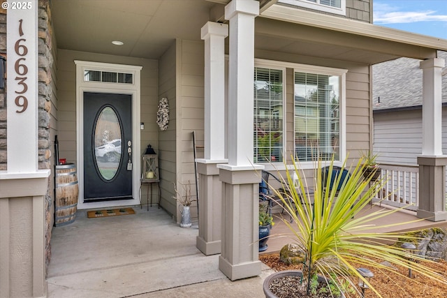 view of exterior entry with a porch