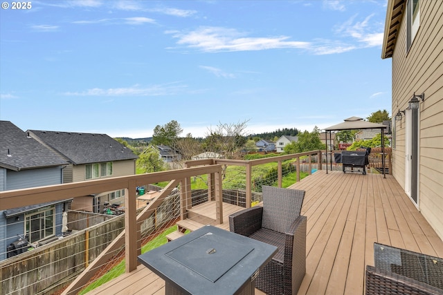deck with a gazebo and a residential view