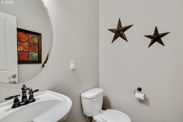 bathroom with toilet and a sink