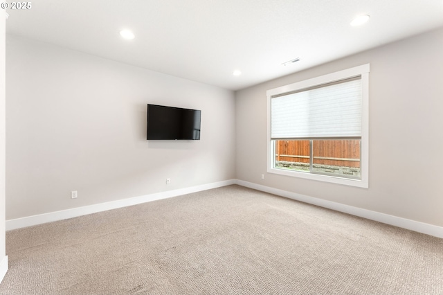 carpeted empty room featuring recessed lighting and baseboards