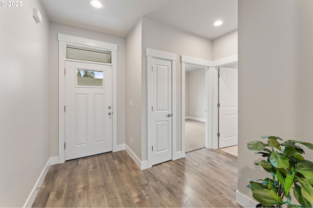 entryway featuring recessed lighting, wood finished floors, and baseboards