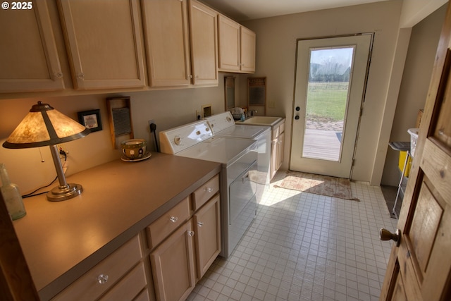 clothes washing area featuring cabinet space, independent washer and dryer, and light tile patterned floors