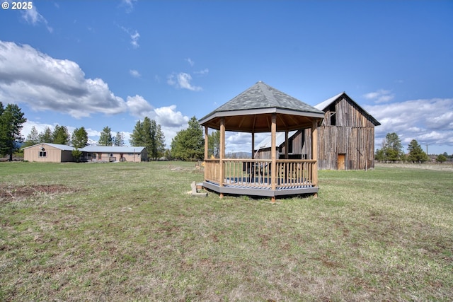 view of grassy yard featuring a gazebo, an outdoor structure, and a barn