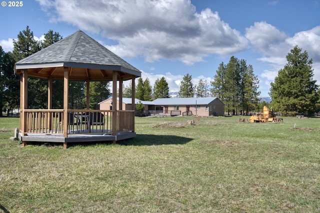 view of green lawn with a gazebo and a wooden deck