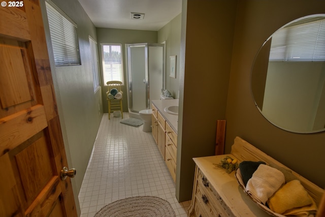 full bathroom with a shower stall, vanity, and tile patterned flooring