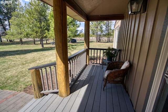 deck with a yard and a porch