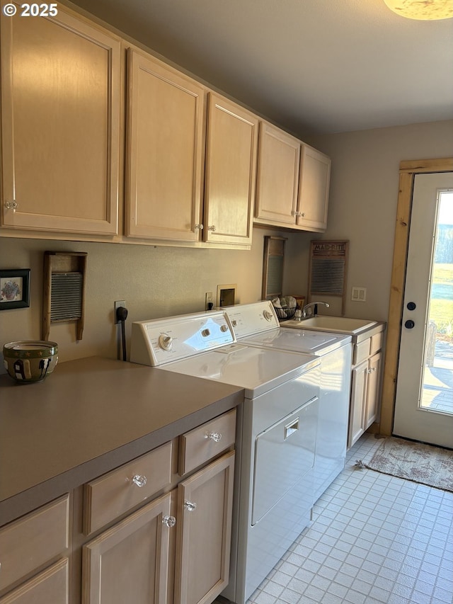 laundry room with cabinet space, washing machine and clothes dryer, and light tile patterned flooring