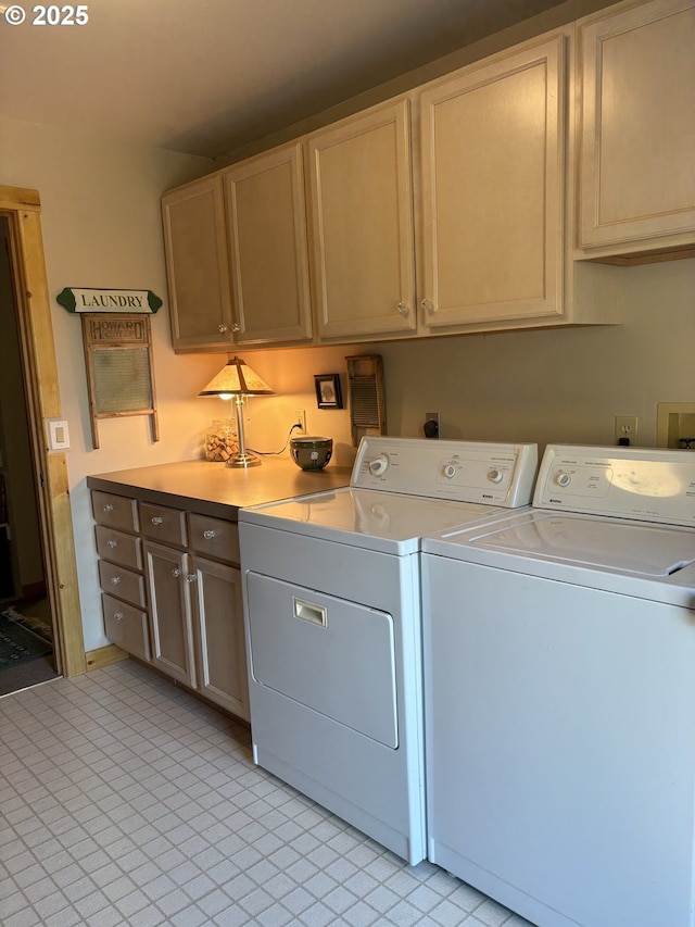 washroom featuring washing machine and dryer, cabinet space, and light tile patterned flooring