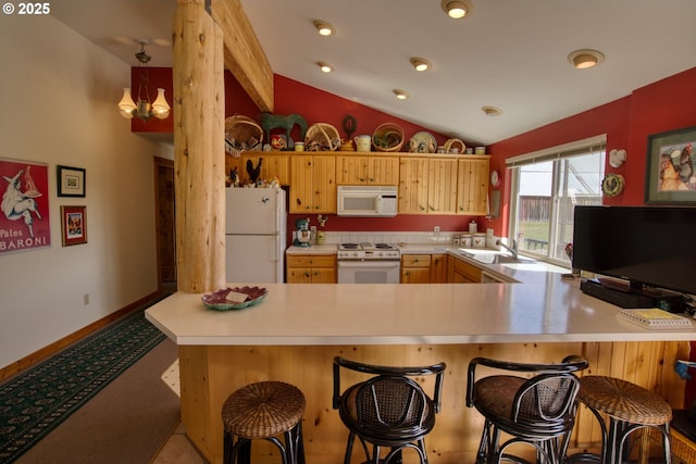 kitchen with white appliances, a sink, light countertops, a peninsula, and vaulted ceiling