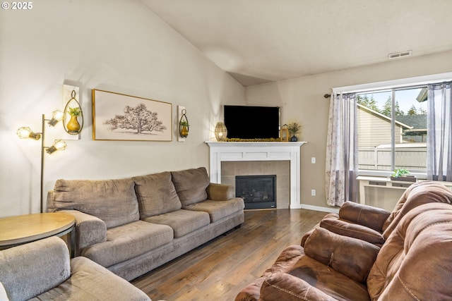 3276 S Mountain View Dr, Albany, OR 97322 - living area featuring dark wood-type flooring, vaulted ceiling, and a tiled fireplace