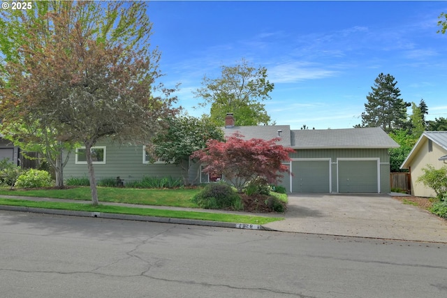 2720 Taylor St, Eugene, OR 97405 - obstructed view of property with a garage, a chimney, and concrete driveway
