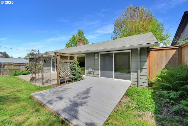 2720 Taylor St, Eugene, OR 97405 - rear view of house featuring a lawn, fence, a wooden deck, and a chimney