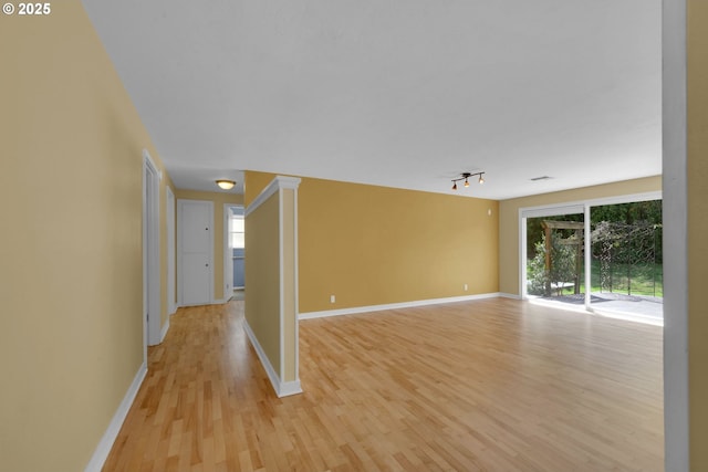 2720 Taylor St, Eugene, OR 97405 - unfurnished room with baseboards, light wood finished floors, and track lighting