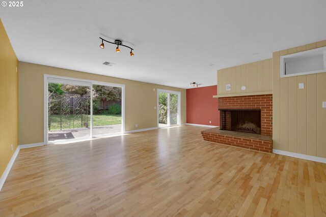 2720 Taylor St, Eugene, OR 97405 - unfurnished living room featuring visible vents, baseboards, wood finished floors, and a fireplace