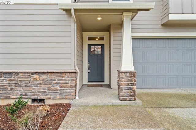 view of exterior entry with a garage