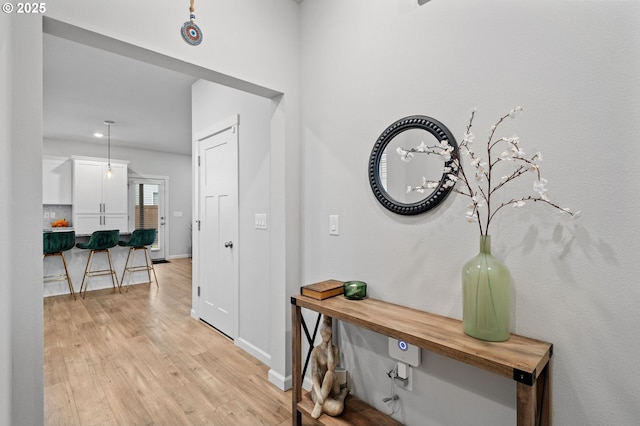 hall with light hardwood / wood-style floors