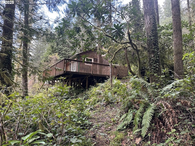 26015 NE Lucia Falls Rd, Yacolt, WA 98675 - back of house with a deck and a forest view