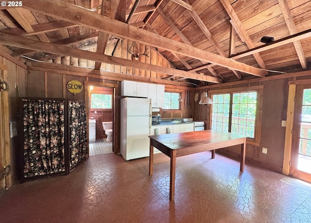 26015 NE Lucia Falls Rd, Yacolt, WA 98675 - kitchen featuring freestanding refrigerator, white cabinetry, wooden ceiling, healthy amount of natural light, and wooden walls