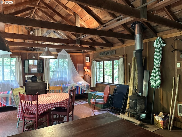 26015 NE Lucia Falls Rd, Yacolt, WA 98675 - dining area featuring a wood stove, healthy amount of natural light, and wood walls