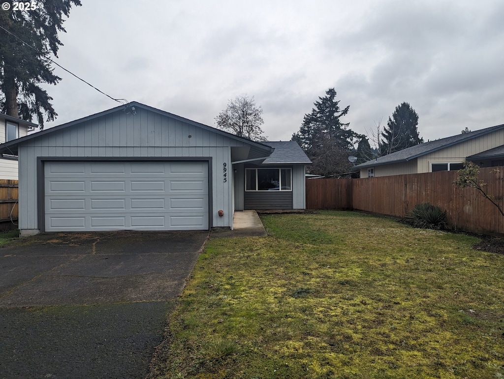 single story home with a garage and a front yard