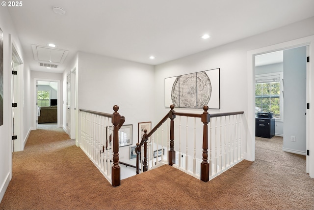 hall with attic access, carpet flooring, an upstairs landing, healthy amount of natural light, and recessed lighting