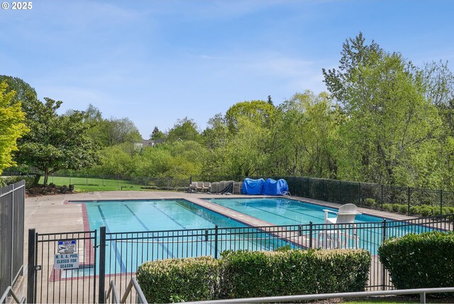 10215 SW Snowgoose Pl, Beaverton, OR 97007 - community pool with fence, view of scattered trees, and a patio area