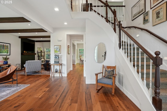 entryway featuring wood finished floors, recessed lighting, stairway, baseboards, and beam ceiling