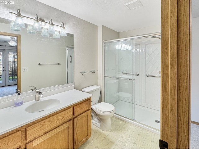 bathroom with vanity, french doors, a shower with shower door, and toilet