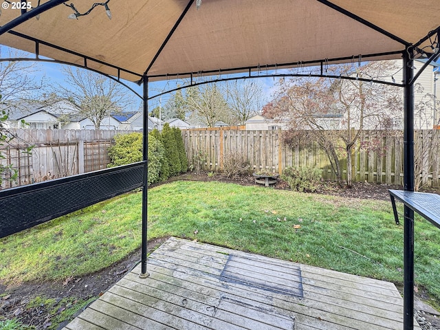 wooden deck with a yard and a gazebo